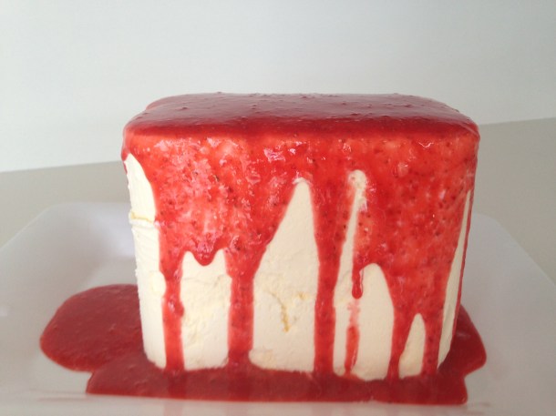 Strawberry coulis poured on top of ice cream.