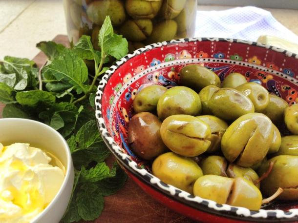 Pickled olives with labne and fresh mint leaves