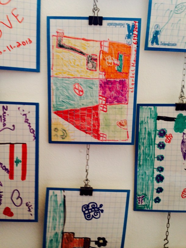 Children's art work hangs on the wall of the workshop room, at MACAM.